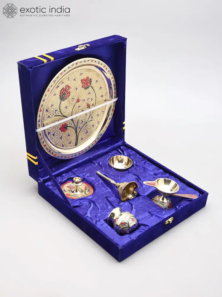 Brass puja thali set open in its blue velvet box