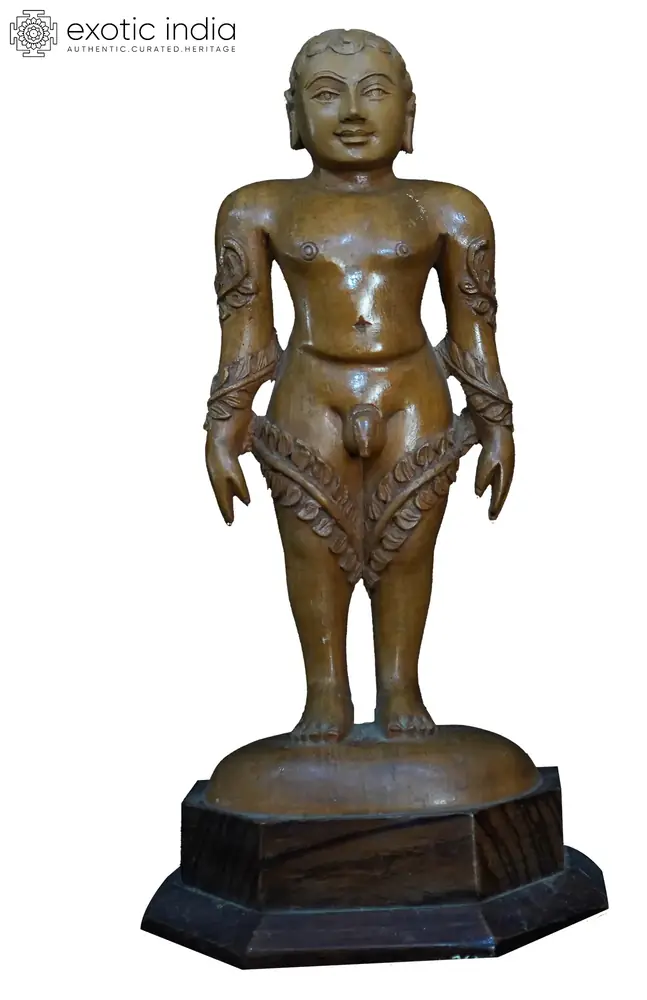 White wood Mahavira standing on a dark base, front view