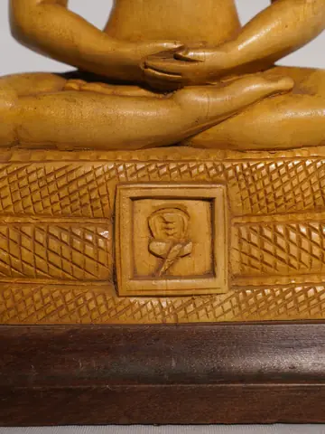Close view of the carved panel on the base