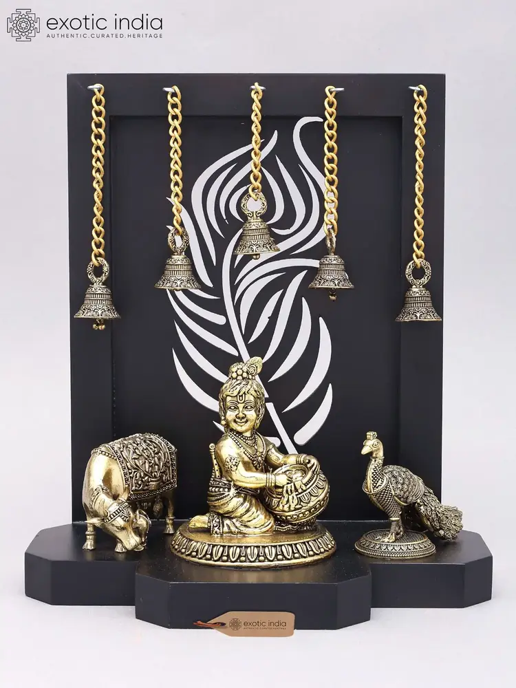 Butter Krishna with cow and peacock before the black frame