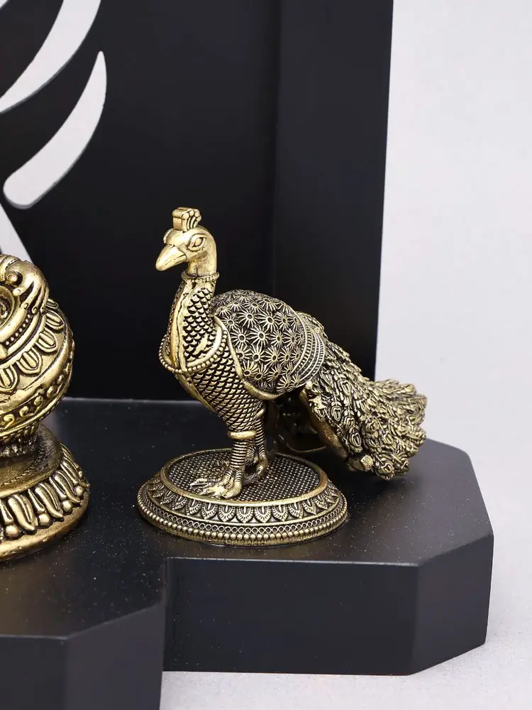 The brass peacock on the wood base