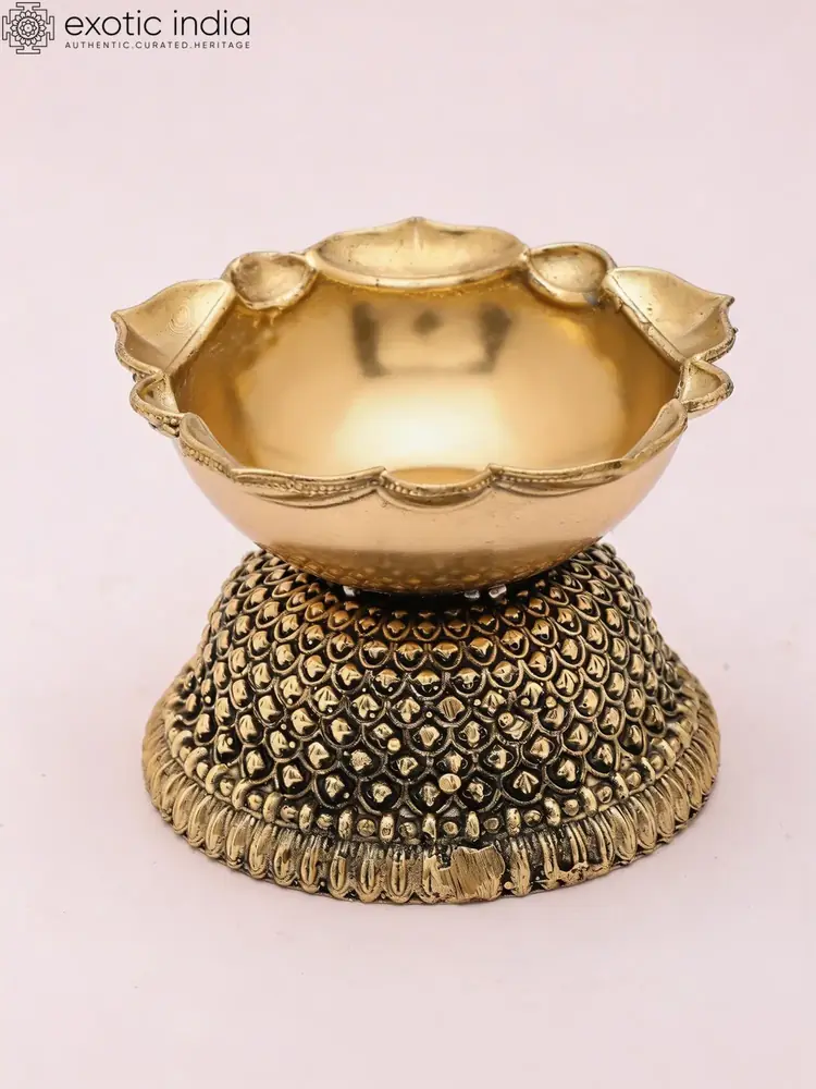 Brass diya with a scalloped bowl and beaded base, front view