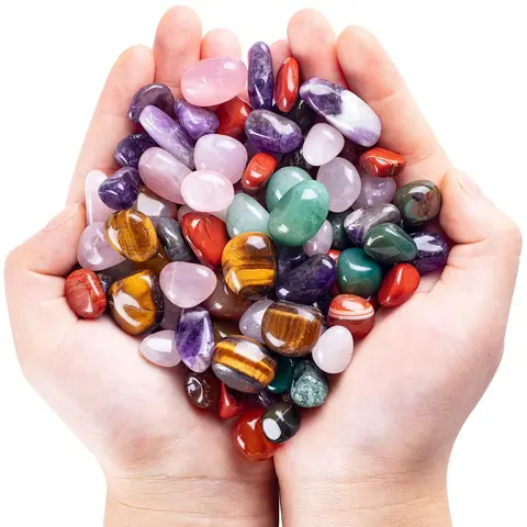 Two cupped hands holding mixed tumbled stones