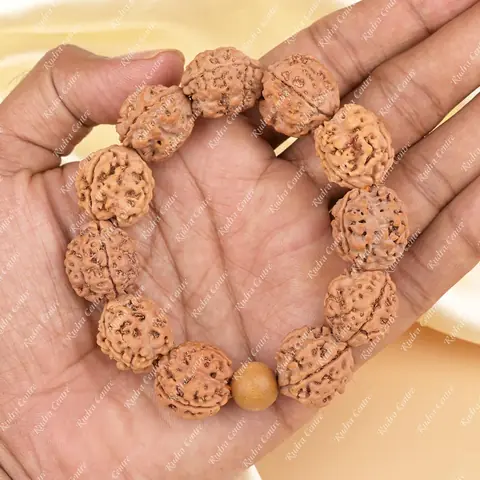 The bracelet held in a hand to show its size