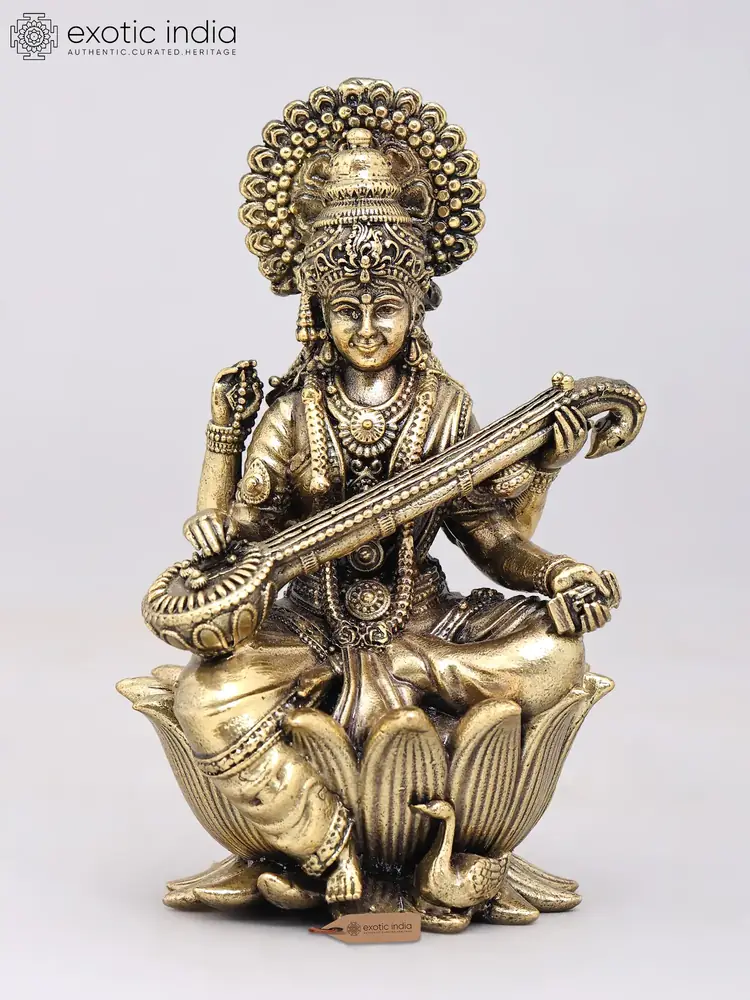 Brass Saraswati seated on a lotus, front view