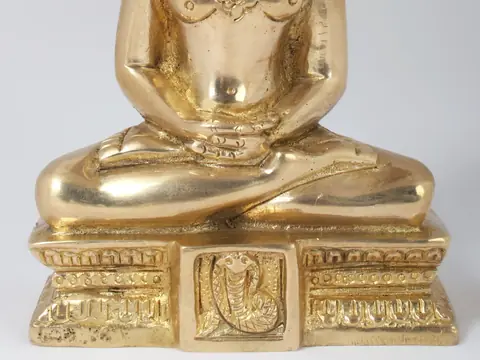 Close view of the seated hands and carved base