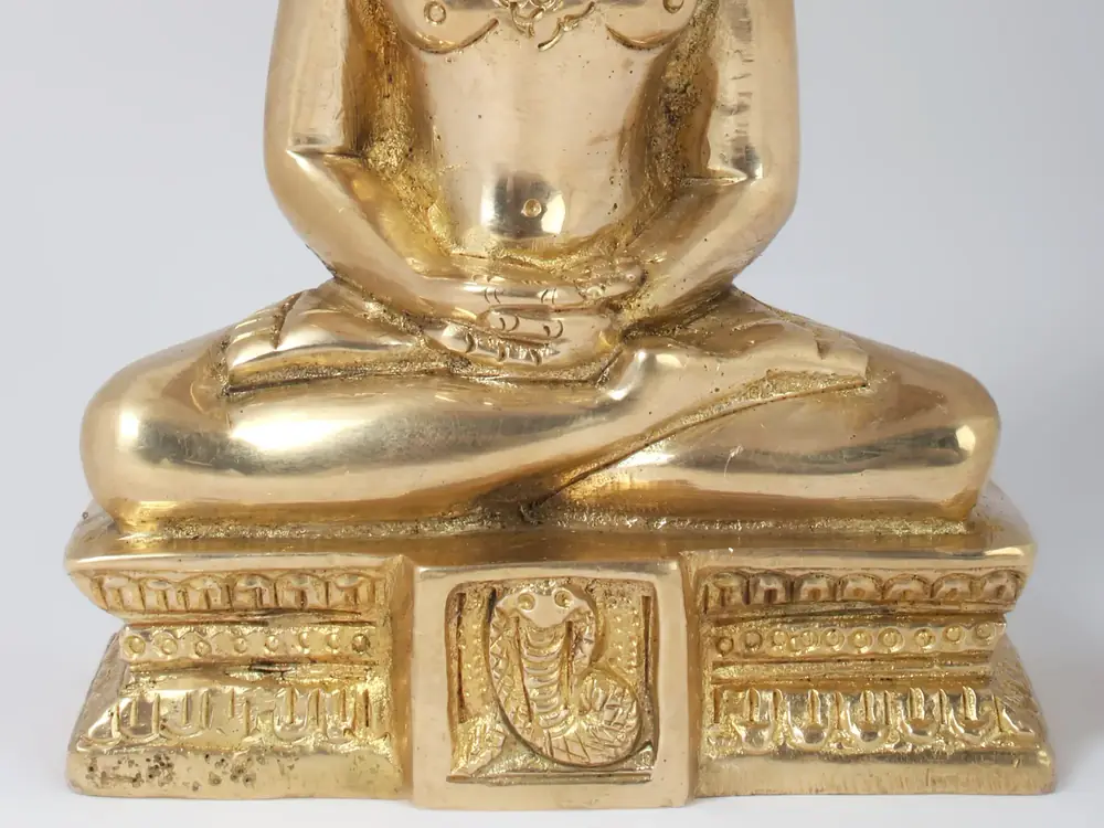 Close view of the seated hands and carved base