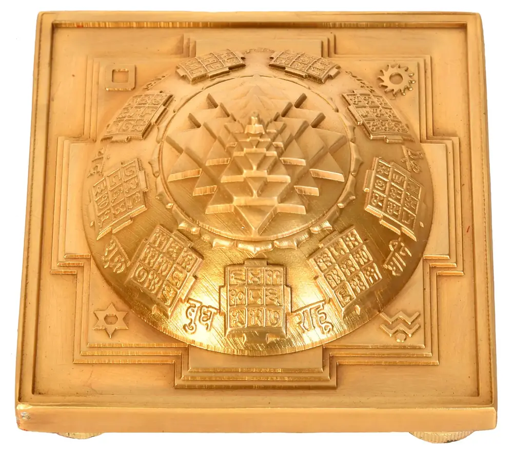 Domed brass Shri Yantra on a square base seen from above