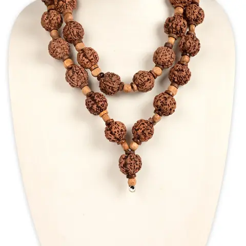 The mala worn on a neck display, in two strands with a drop bead