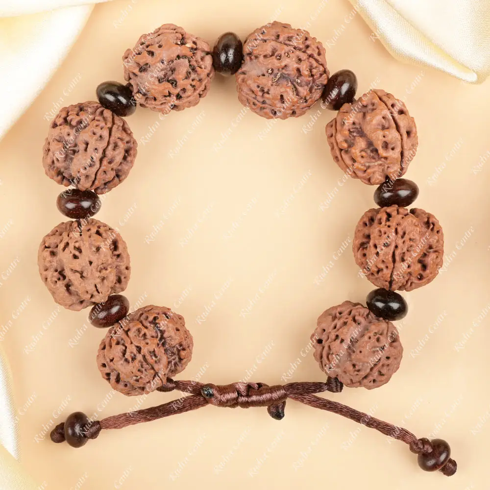 Bracelet of rudraksha beads and dark red sandalwood beads laid flat