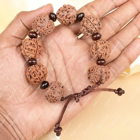 The bracelet held in a hand to show its size