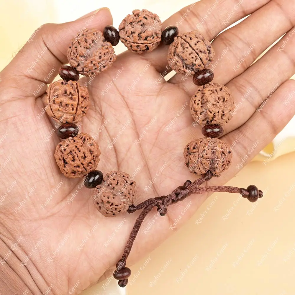 The bracelet held in a hand to show its size
