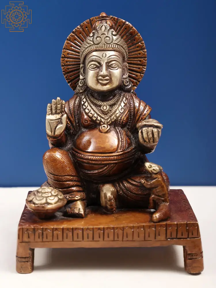 Brass Kubera seated on a chowki, front view