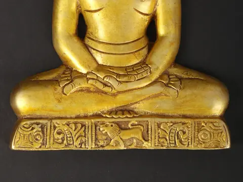 Close view of the hands and carved base