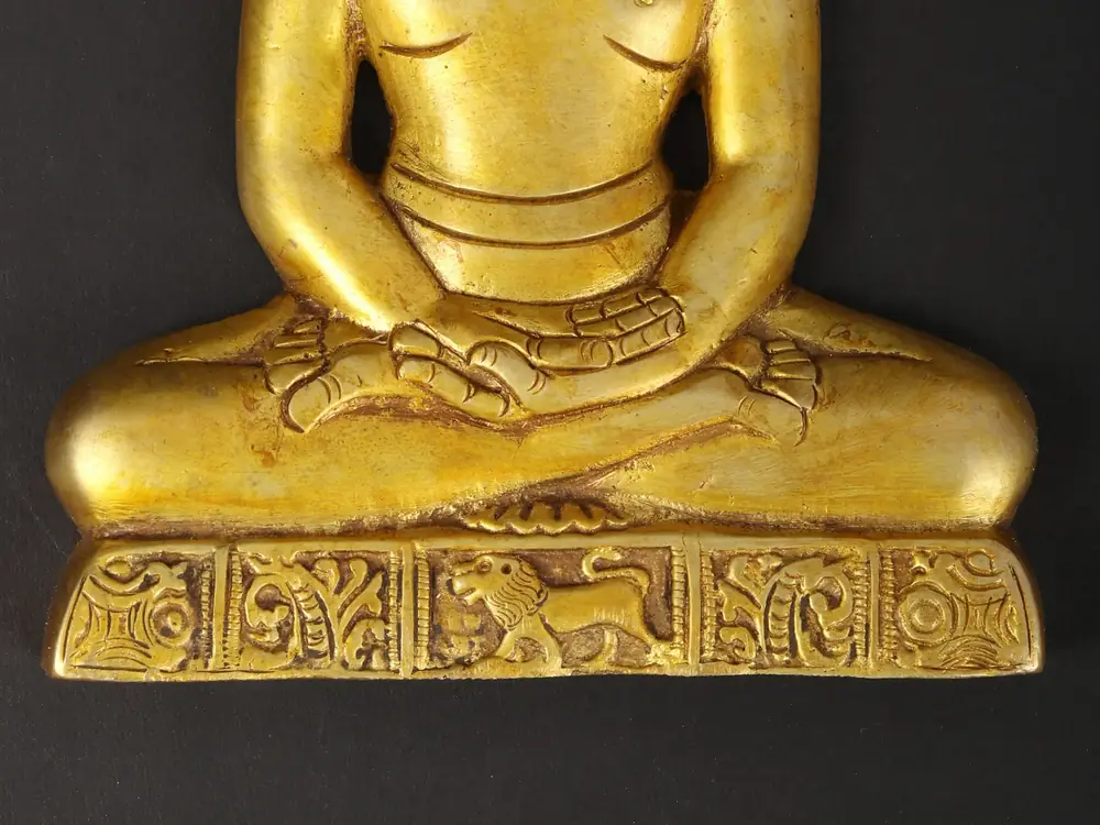 Close view of the hands and carved base