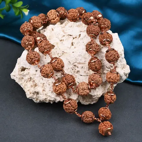 The mala resting on a white rock