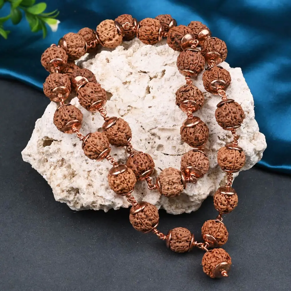 The mala resting on a white rock