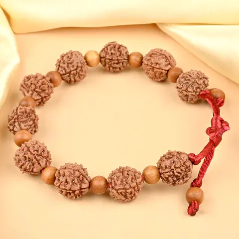 The bracelet on cream cloth showing the adjustable cord