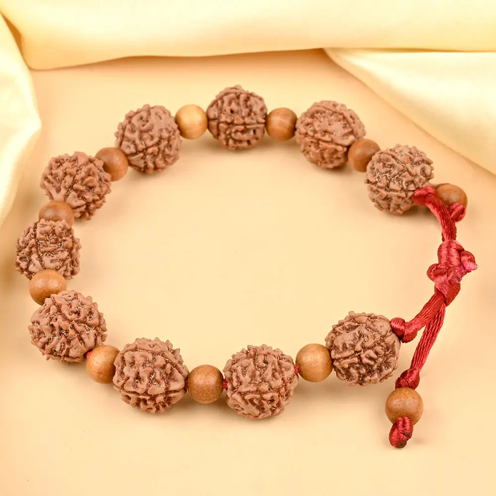 The bracelet on cream cloth showing the adjustable cord
