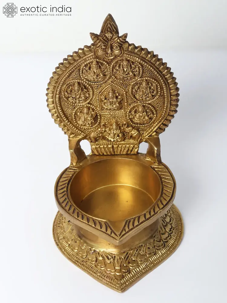 Brass Ashtalakshmi lamp with a carved back plate, front view