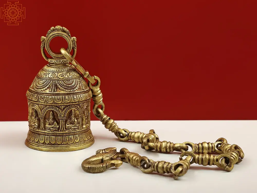 Brass Navagraha temple bell lying with its chain
