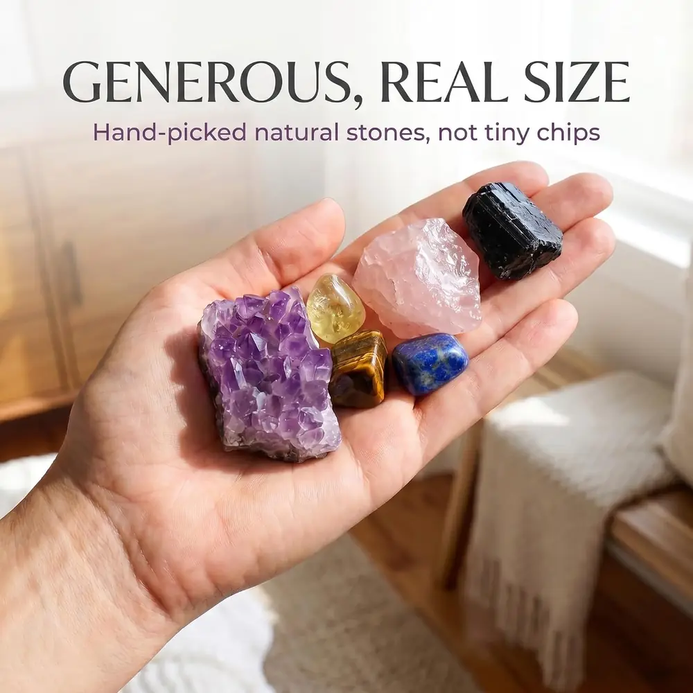 A hand holding an amethyst cluster, a black stone and a golden stone