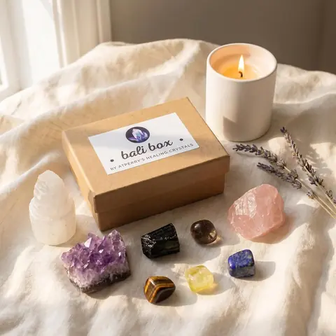 The box on a table with a candle, rose quartz and amethyst