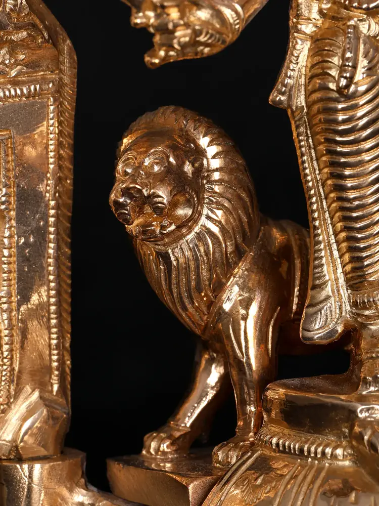 Close view of the lion beside her