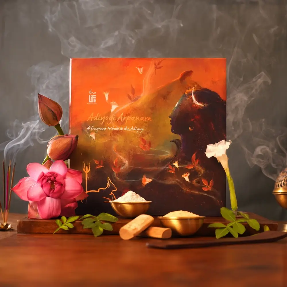 Adiyogi incense gift set with a box, flowers and powders on a dark tray
