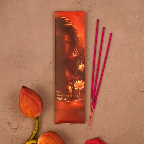 One incense pack with sticks and a lotus flower beside it