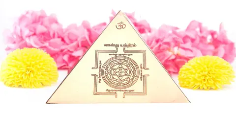 Pyramid face with a carved yantra, shown on pink flowers