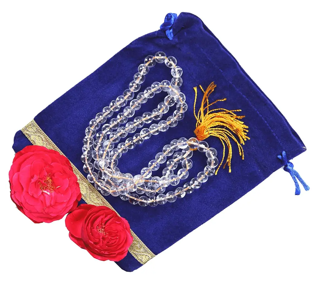 The sphatik mala with a blue pouch and flowers