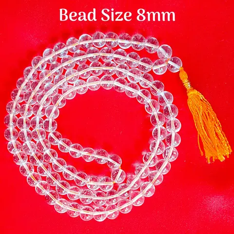 The mala laid in a loop on a pale ground