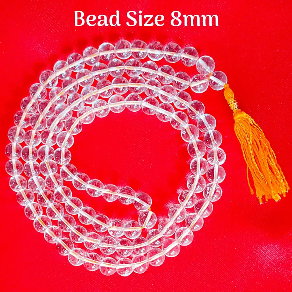 The mala laid in a loop on a pale ground