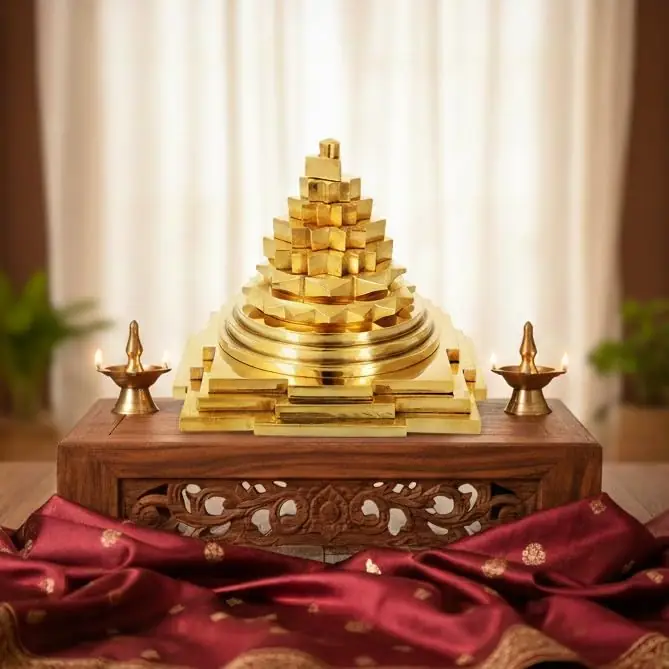 The yantra on a wooden shelf with two small lamps