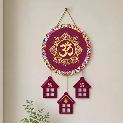 The Om plaque with three hanging house shaped panels on a white ground