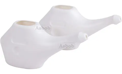 A pair of white neti pots at an angle