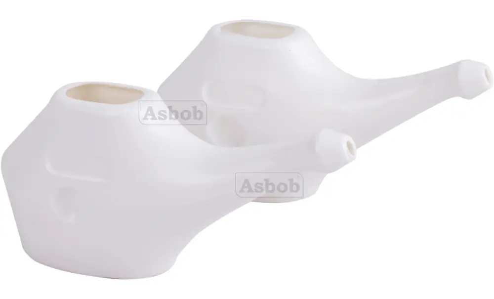 A pair of white neti pots at an angle