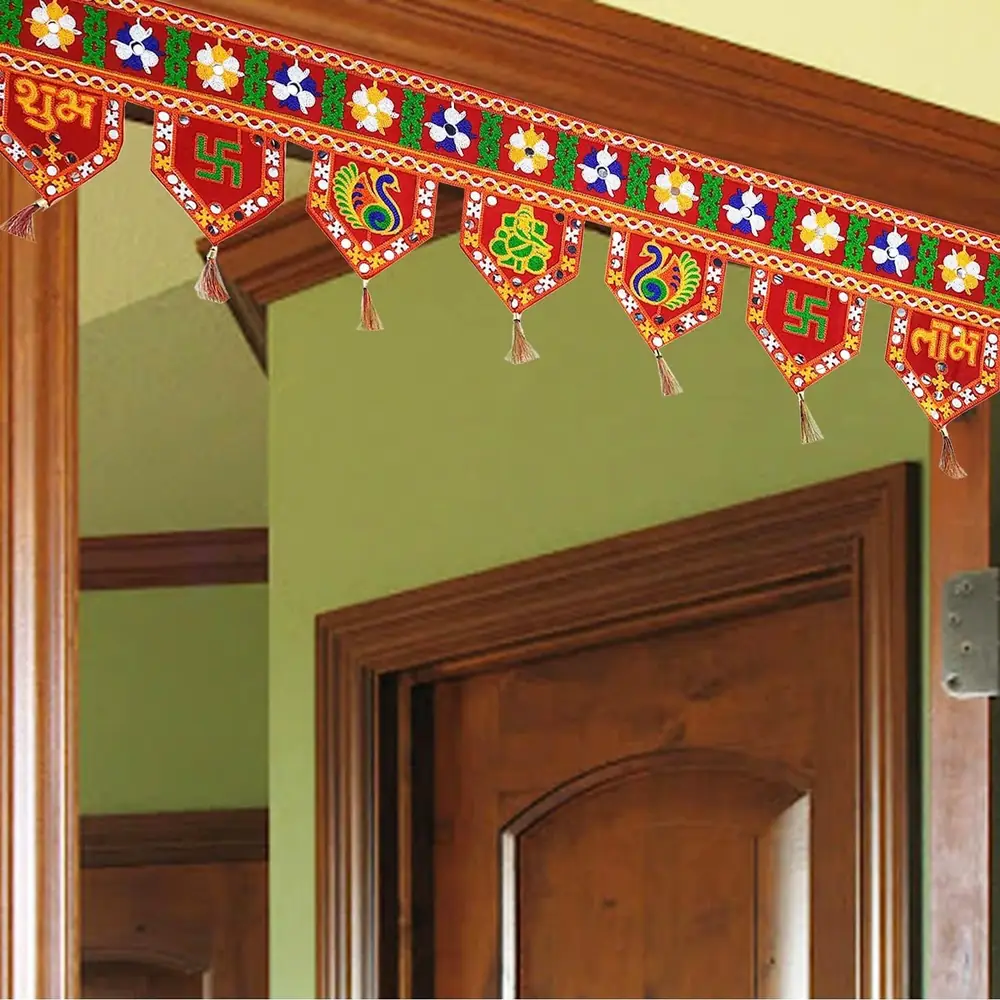 Red Subh Labh toran hanging across a wooden door frame