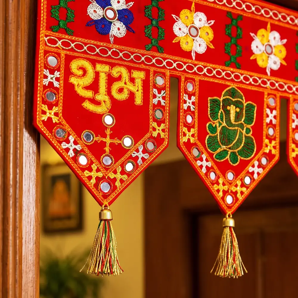 Close view of the Shubh lettering, mirror work and Ganesha panel