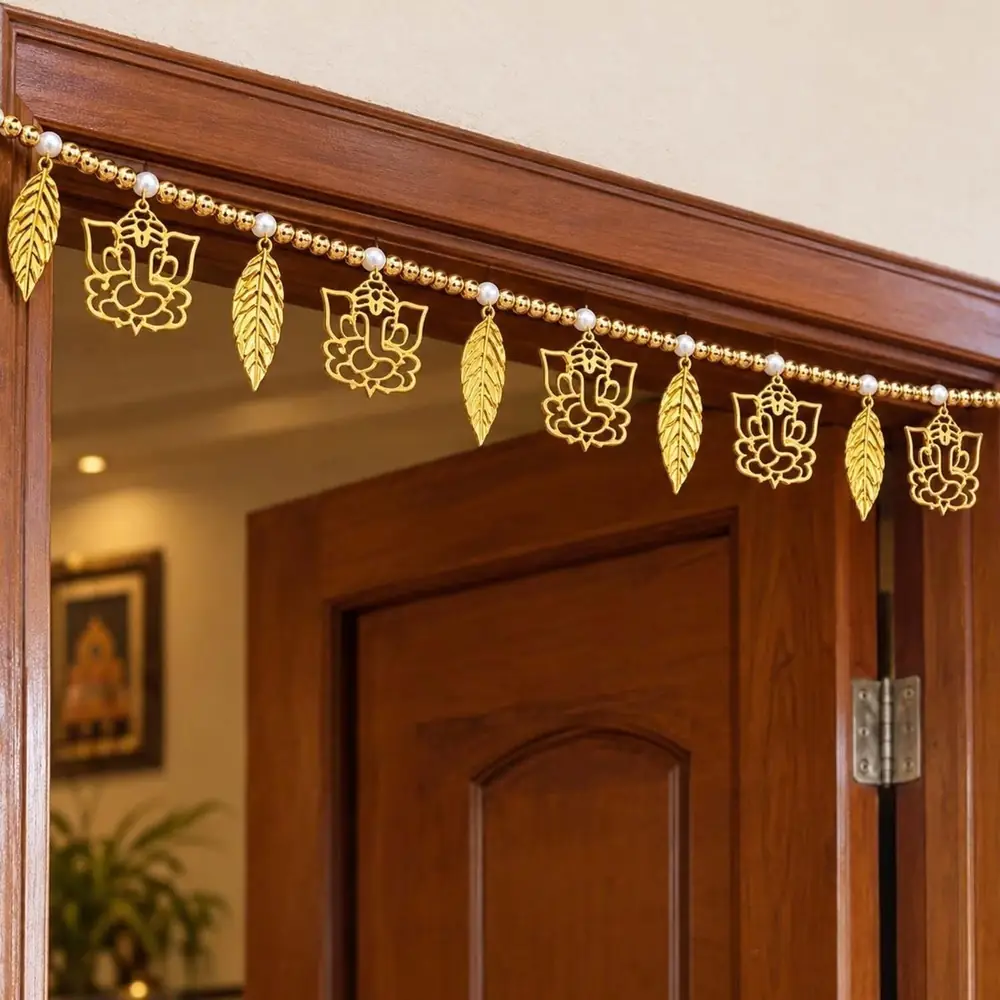 Gold leaf design toran hanging across a wooden door frame