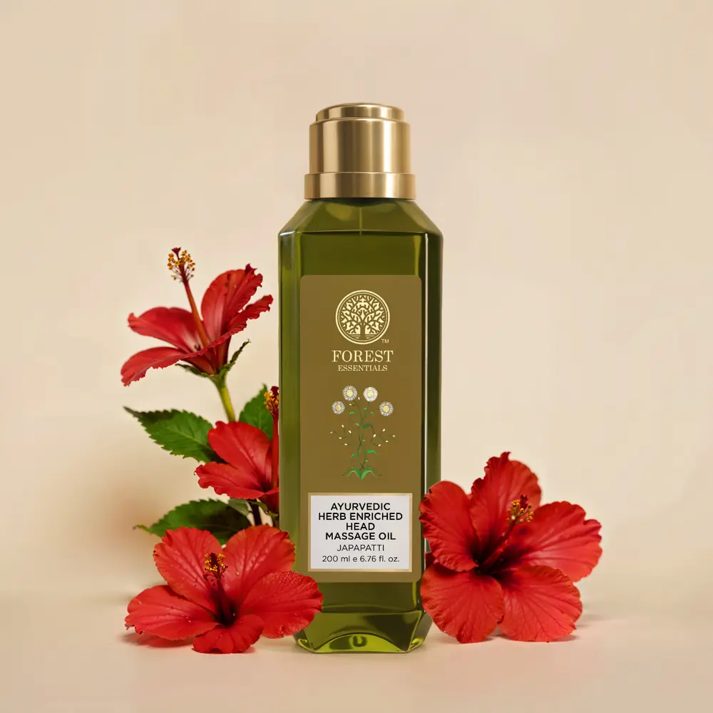 Bottle beside red hibiscus flowers
