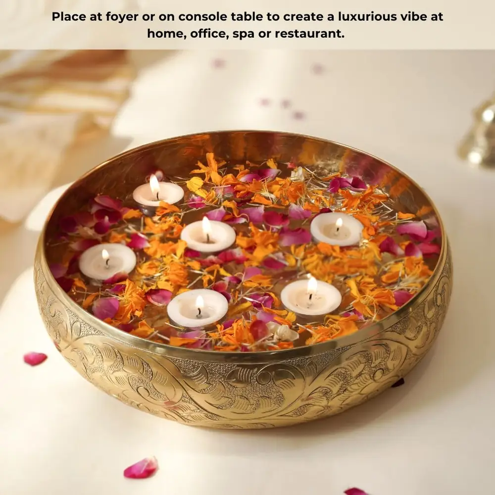 The urli filled with orange petals and floating candles