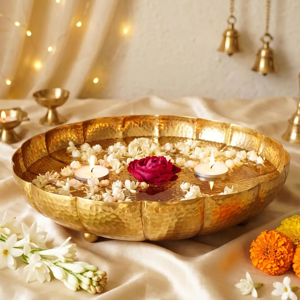 Golden lotus urli bowl with white flowers and a red rose
