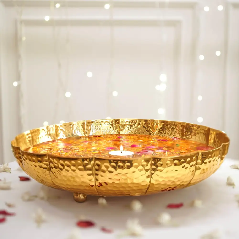 The urli filled with petals and lit by a candle