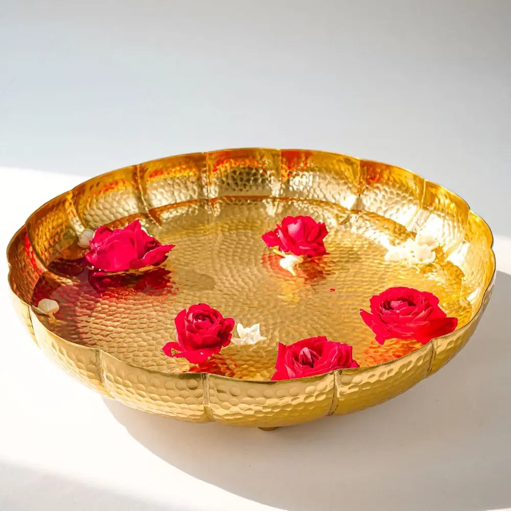 The urli bowl with floating red roses on a white ground