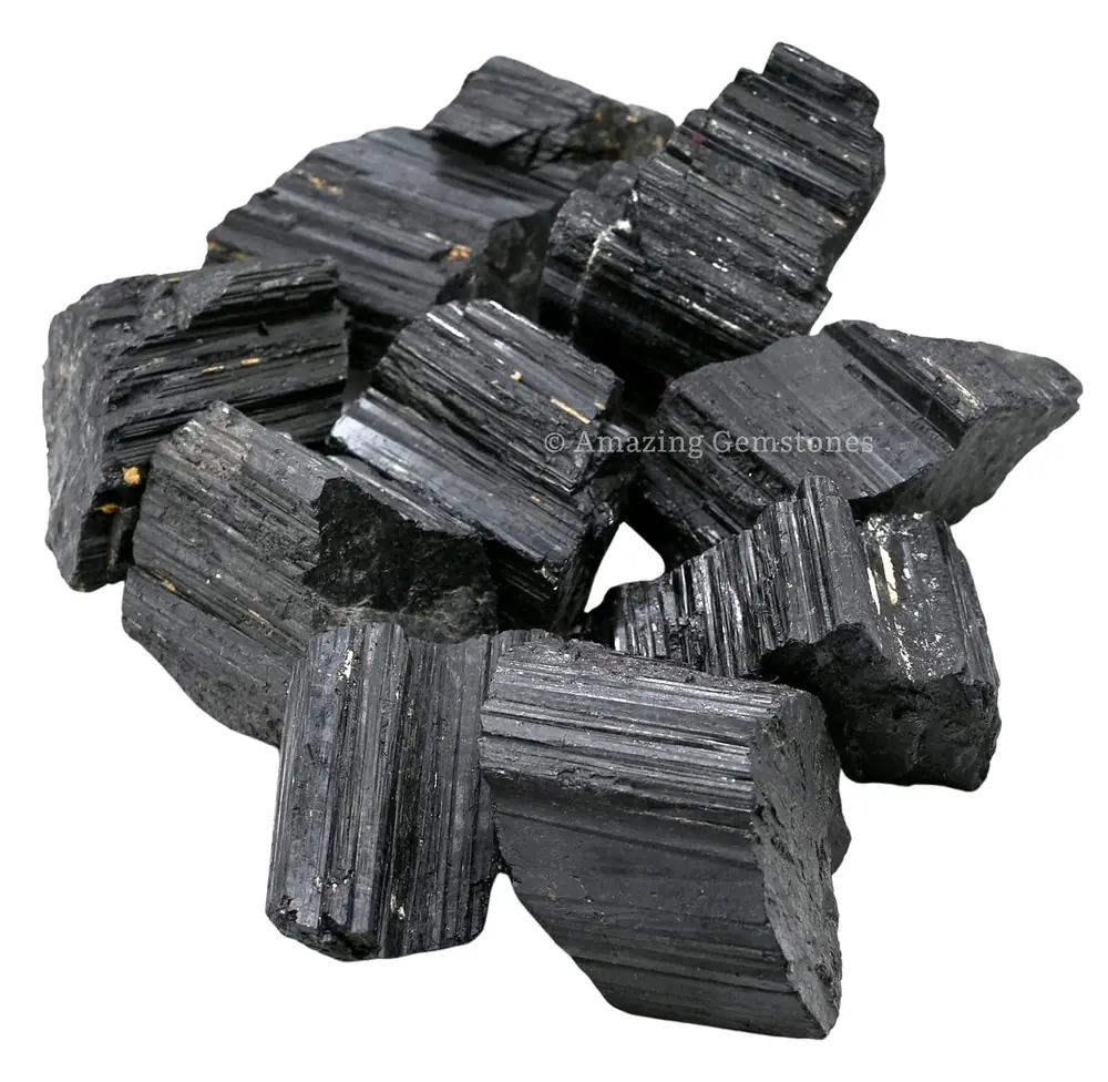Rough black tourmaline pieces on a white ground