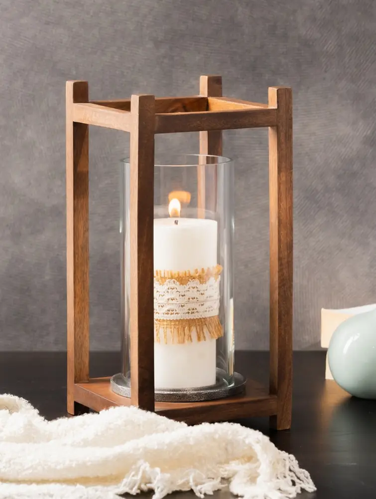 Wooden lantern with a lit pillar candle inside the glass