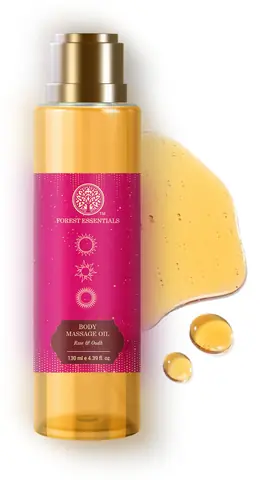 Bottle with a drop of golden oil beside it