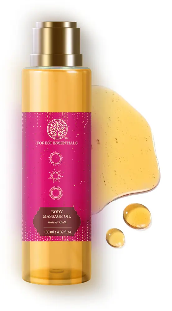 Bottle with a drop of golden oil beside it